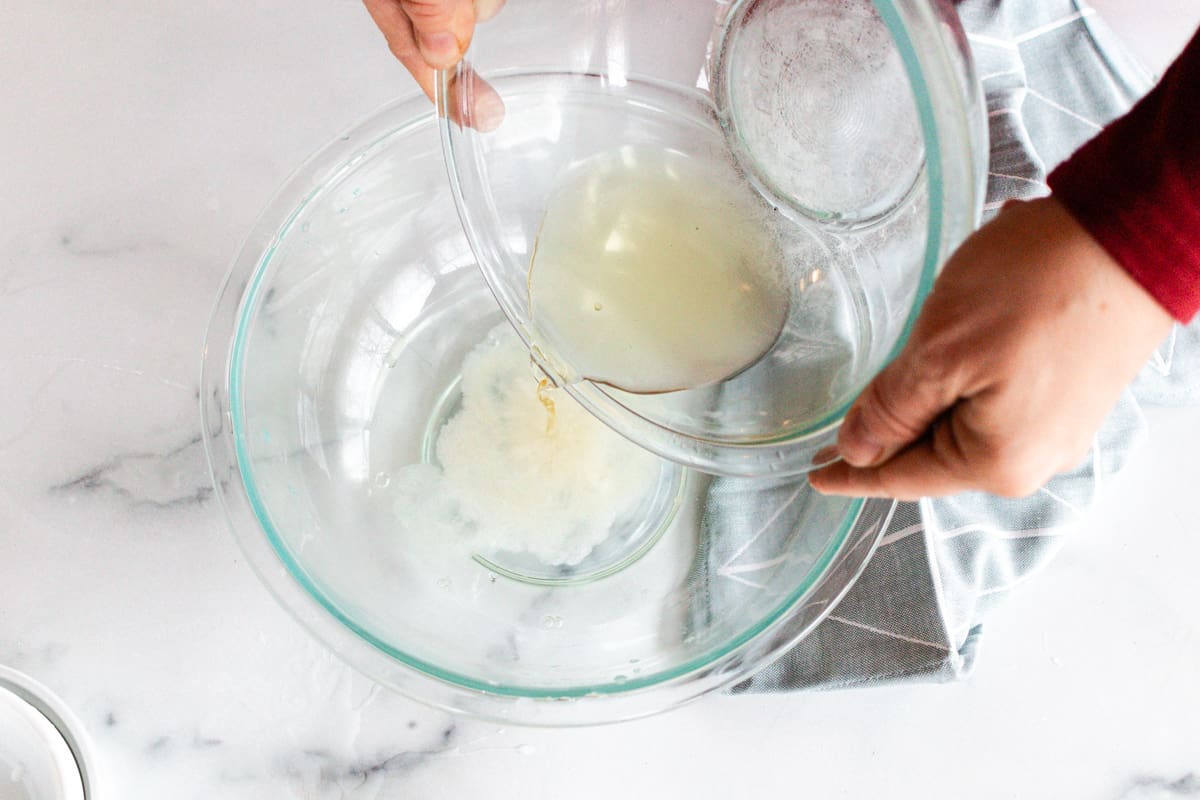 Pouring the melted oils into the water.