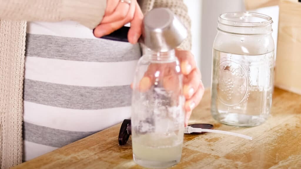 Adding castile soap and water to the shampoo dispenser.