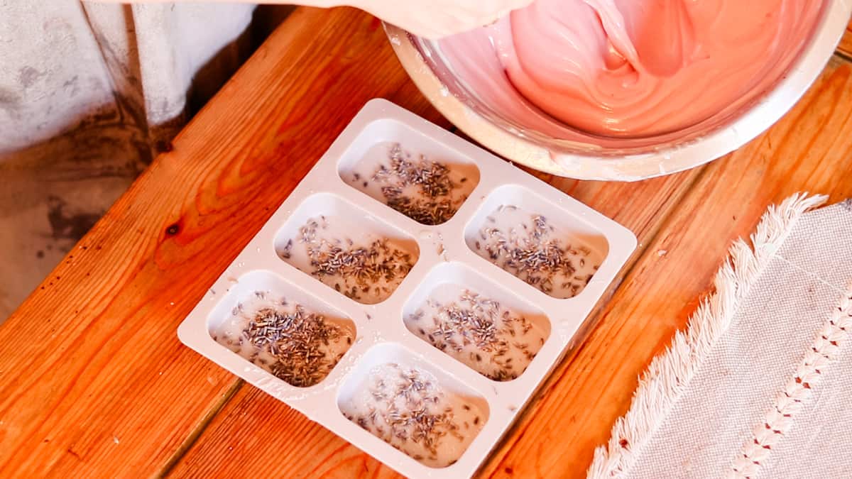 A silicone soap mold with lavender petals sprinkled into the bottom of the mold.