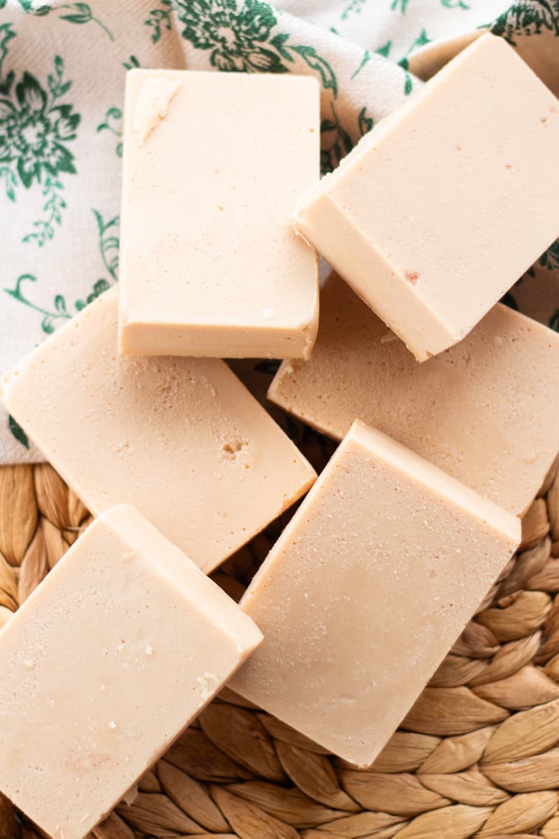 Six bars of DIY soap bars on a woven placemat.