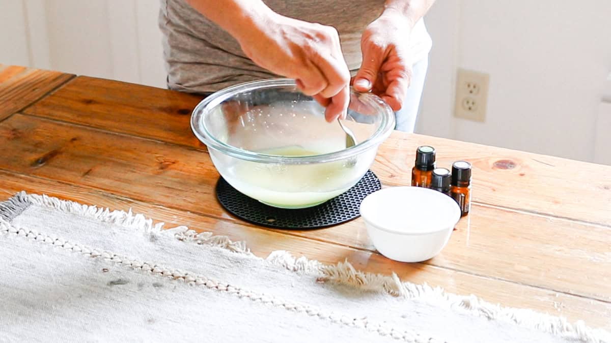 Adding the cornstarch and baking soda to a bowl with melted oils and stirring well. 