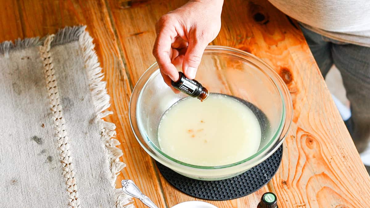 Adding drops of Jasmine essential oil to the bowl with deodorant cream ingredients.