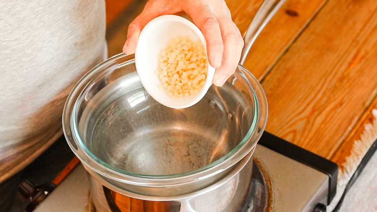 Adding ingredients to a double boiler.