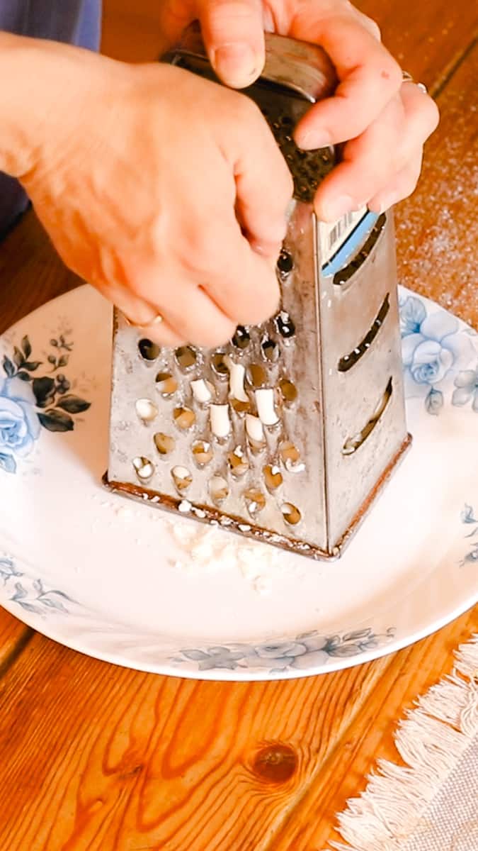 Shredding the soap bar before melting it into the laundry soap. 