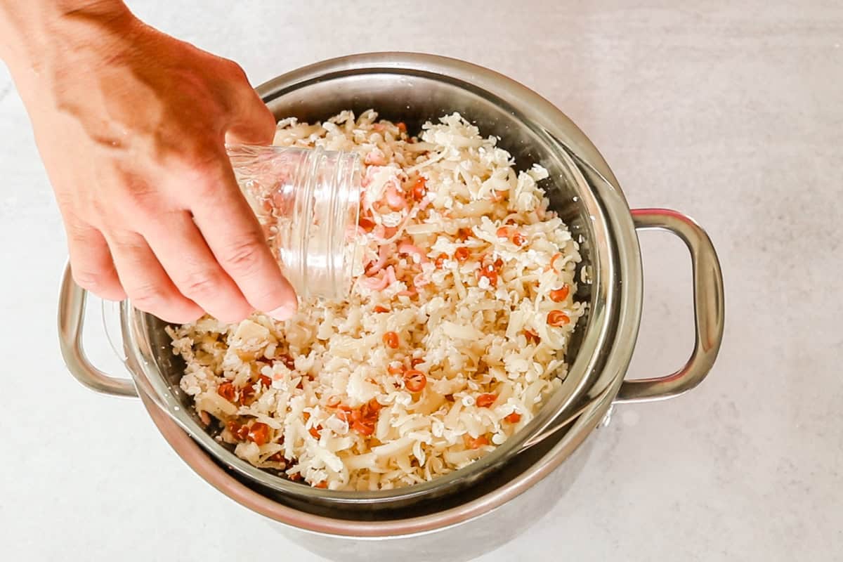 Adding water to shaved soap scraps in a double boiler. 
