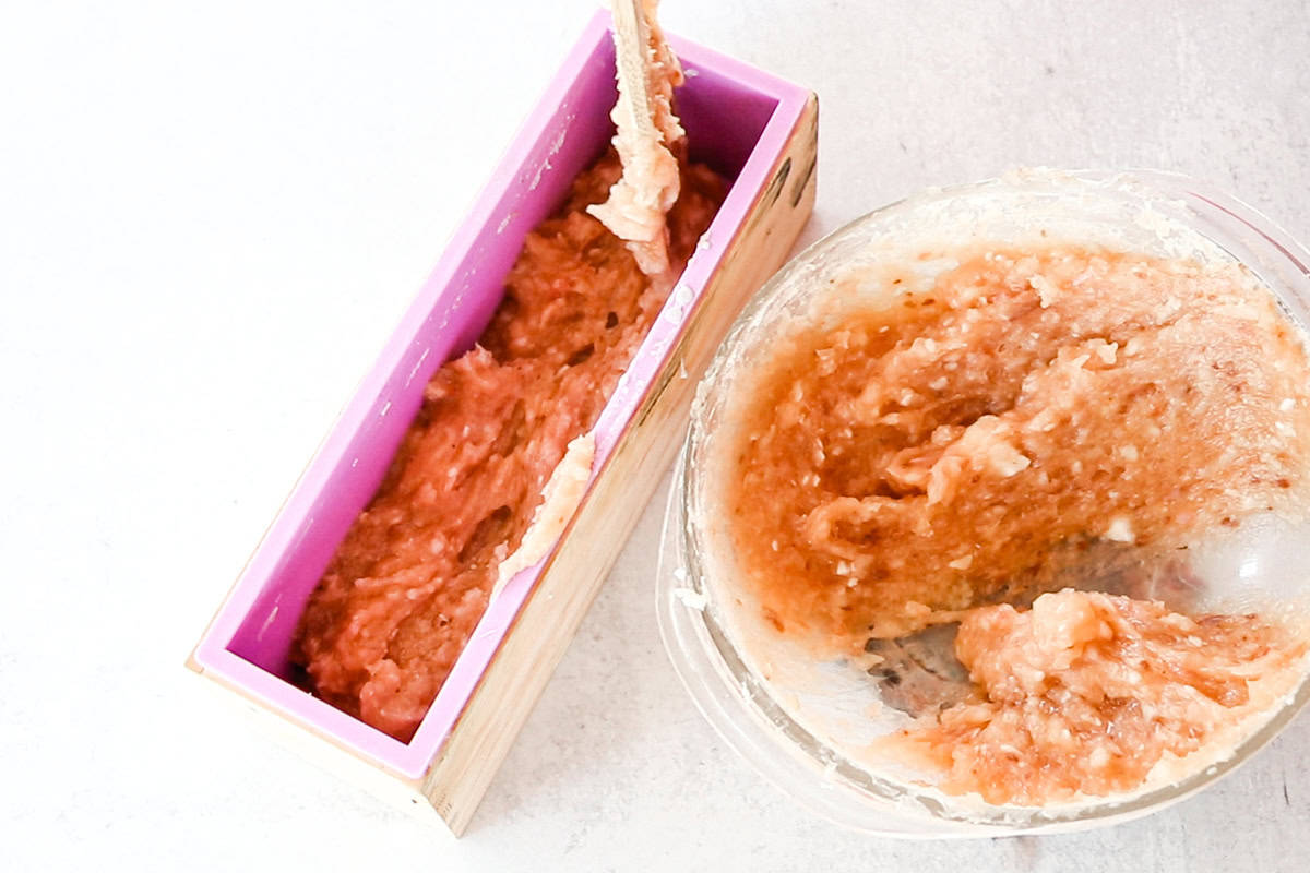 Scooping the melted rebatch soap into a large loaf soap mold. 