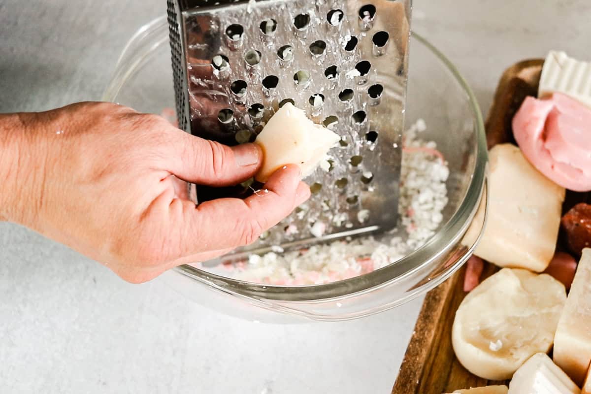 Shredding soap bars with a box grater. 