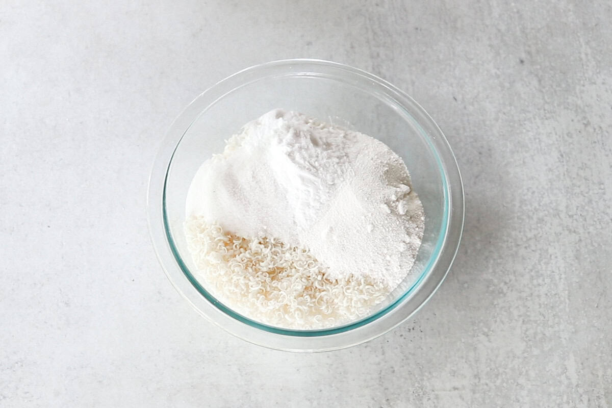A glass bowl with the dry ingredients in it. 