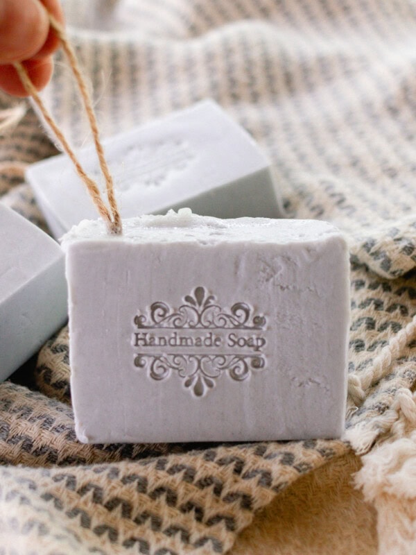 Holding a soap on a rope up so the stamp is visible.