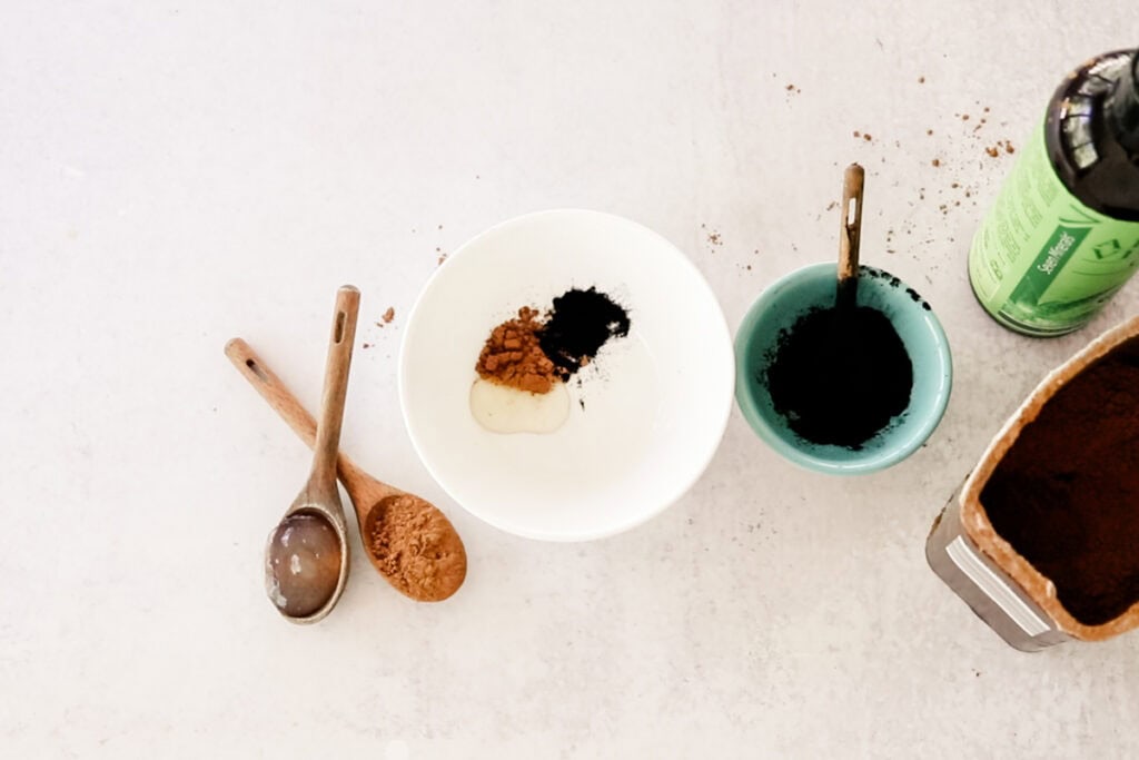 Adding the ingredients for the eyebrow tint to a small bowl. 