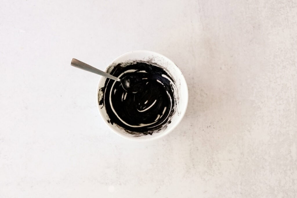 DIY eyebrow tint in a small white bowl after it has been stirred. 