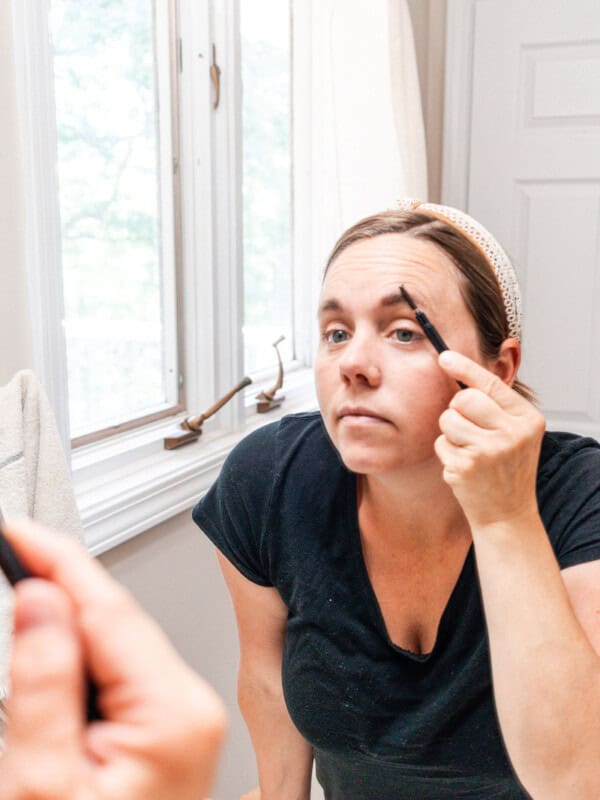 Applying eyebrow tint with an brow applicator.