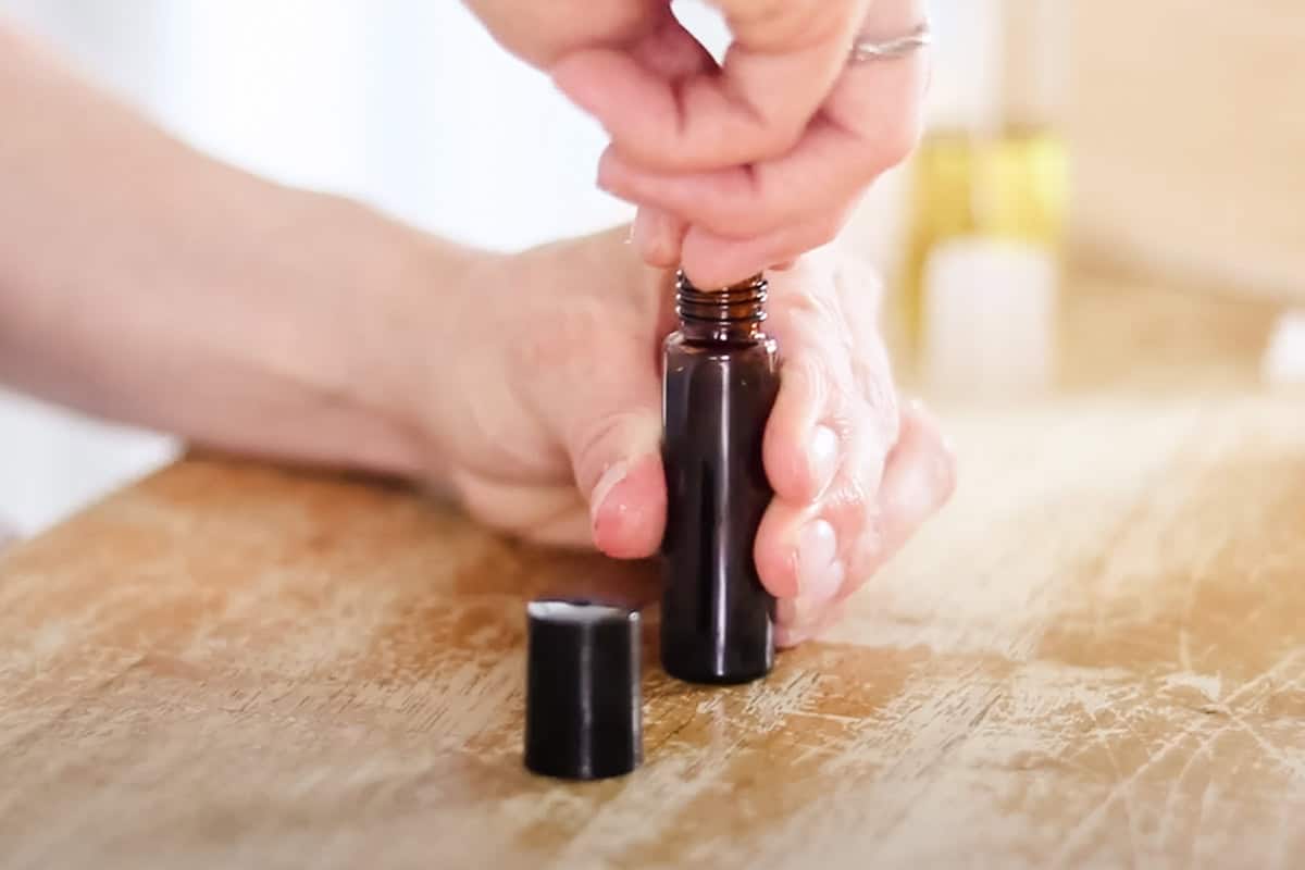 Securing the rollerball top for the growth serum.