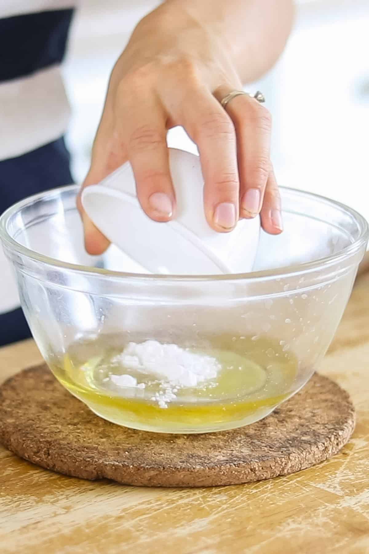 Adding arrowroot powder to the melted deodorant ingredients.