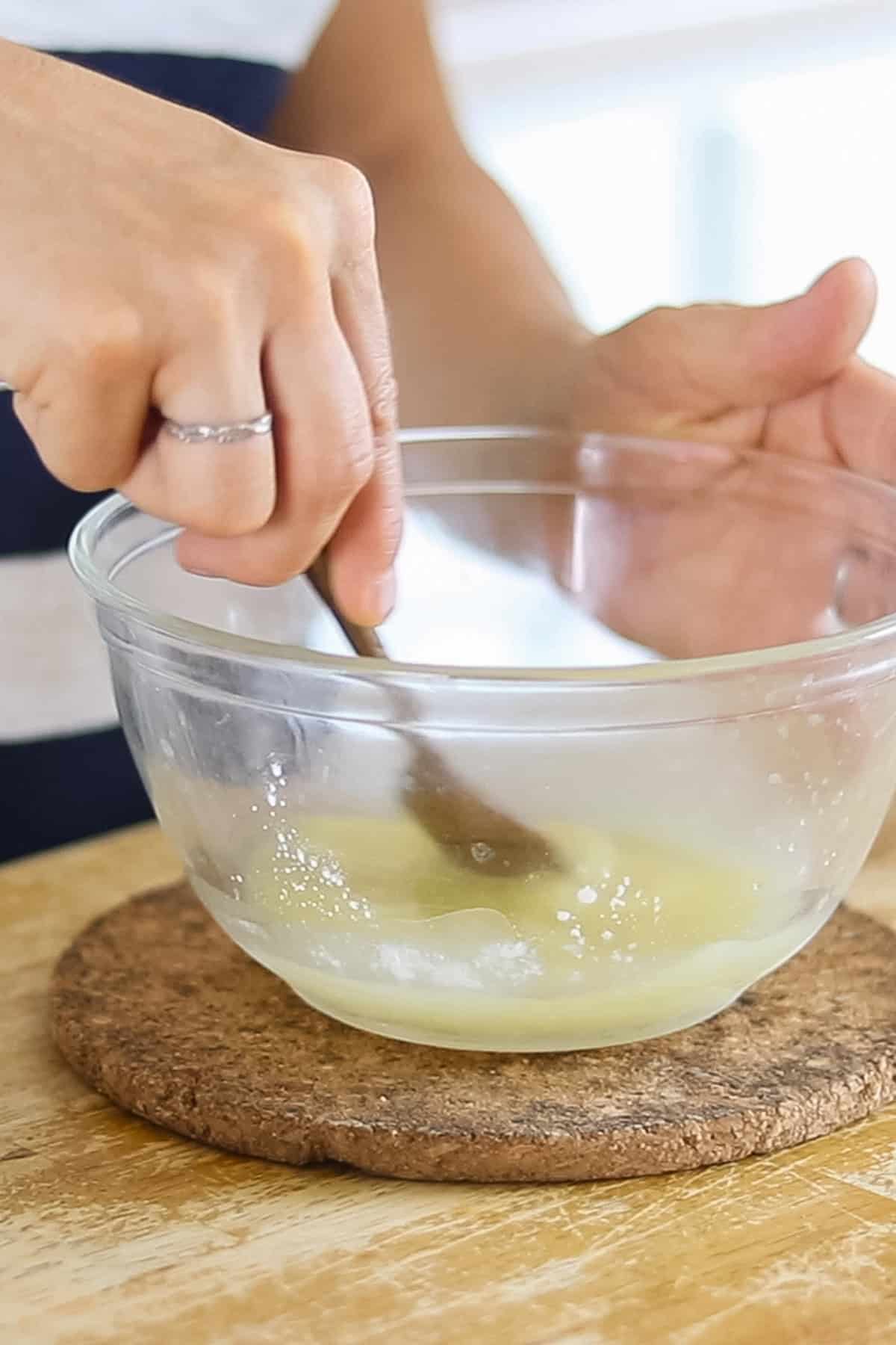 Stirring the ingredients together to make homemade deodorant.