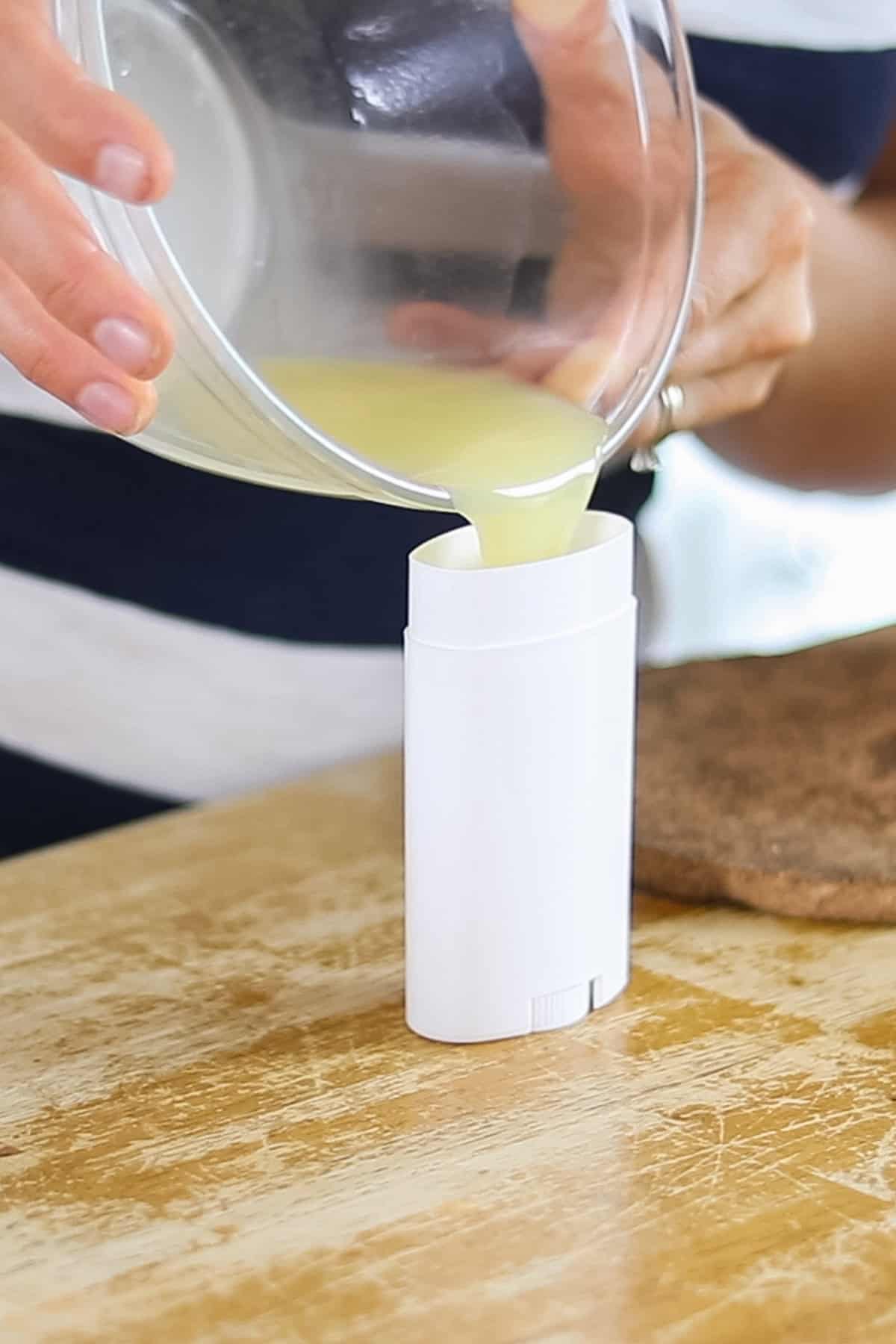 Pouring the mixture into an empty deodorant container.