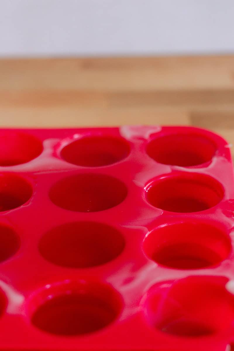 Silicone lotion bar molds with liquid lotion bar batter in them.