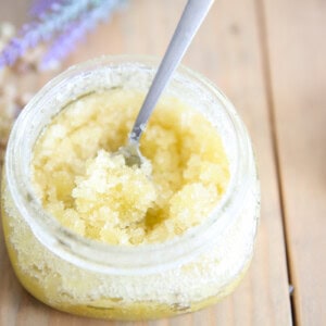 Homemade sugar scrub in mason jar on wooden table.