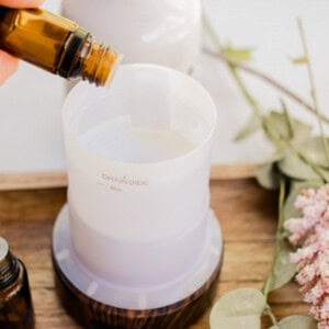 Adding different essential oils to the diffuser reservoir.