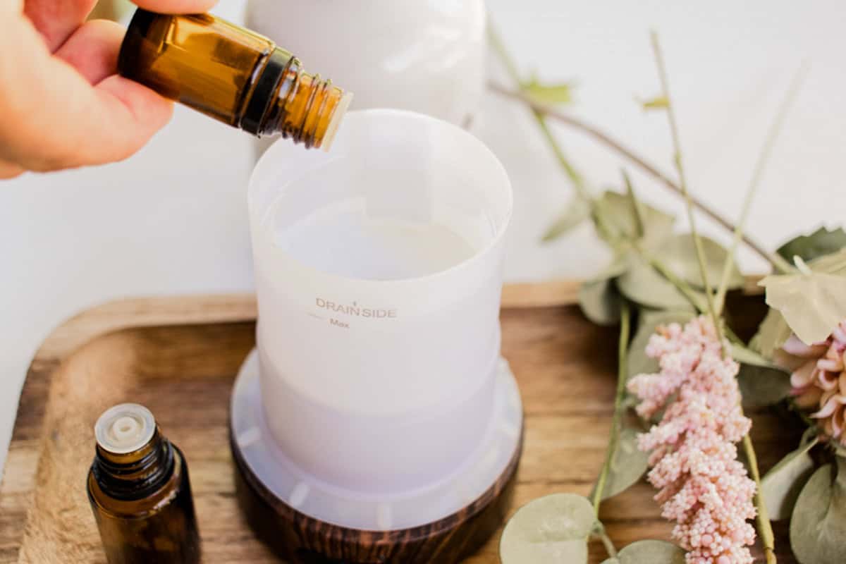 Adding different essential oils to the diffuser reservoir. 