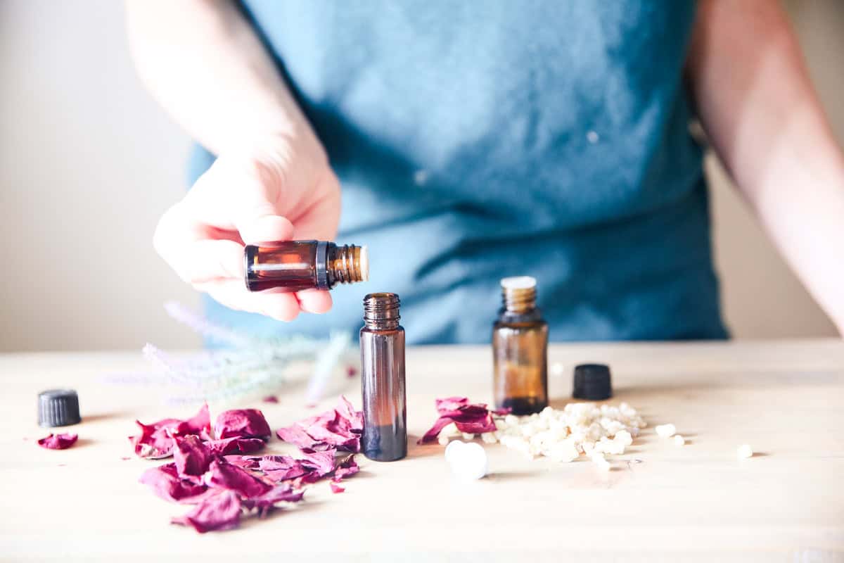 Dropping essential oils into a roller bottle.
