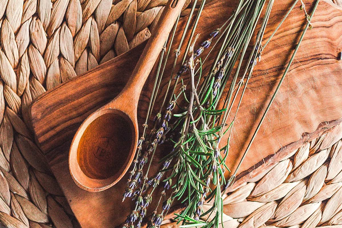 A small wooden spoon with black seed oil to be applied to the hair. 
