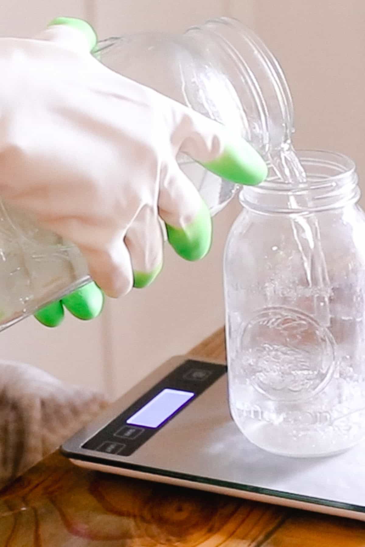 Pouring water into a large mason jar using a kitchen scale.