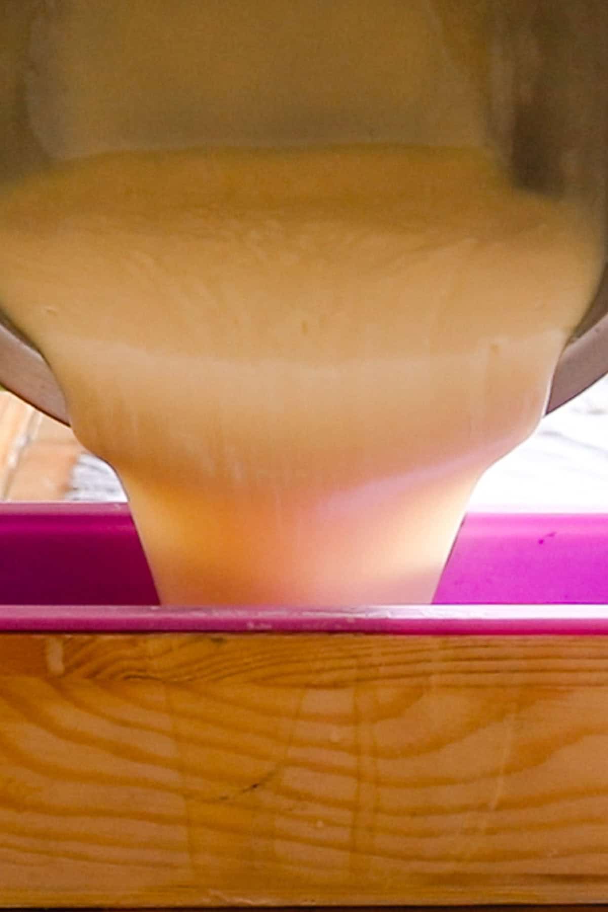 Pouring soap into a large loaf soap mold.