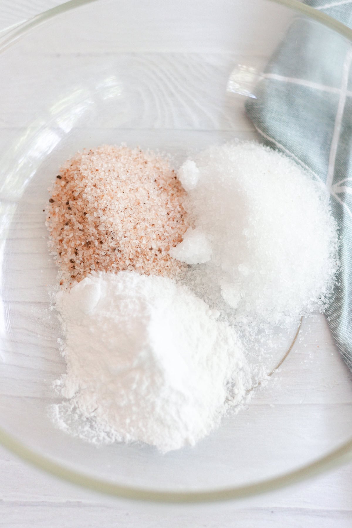 Ingredients for a foot bath poured into a glass bowl.