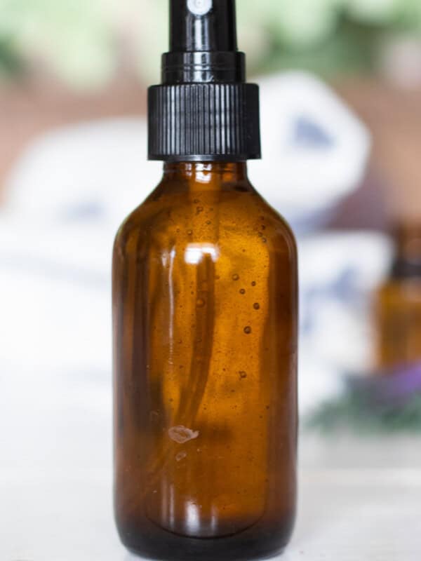 An amber spray bottle of DIY spray deodorant.