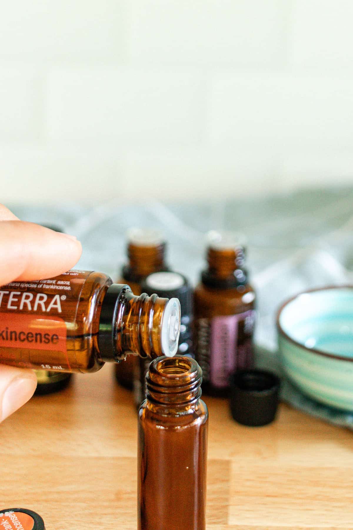 Dropping essential oils into a roller bottle.