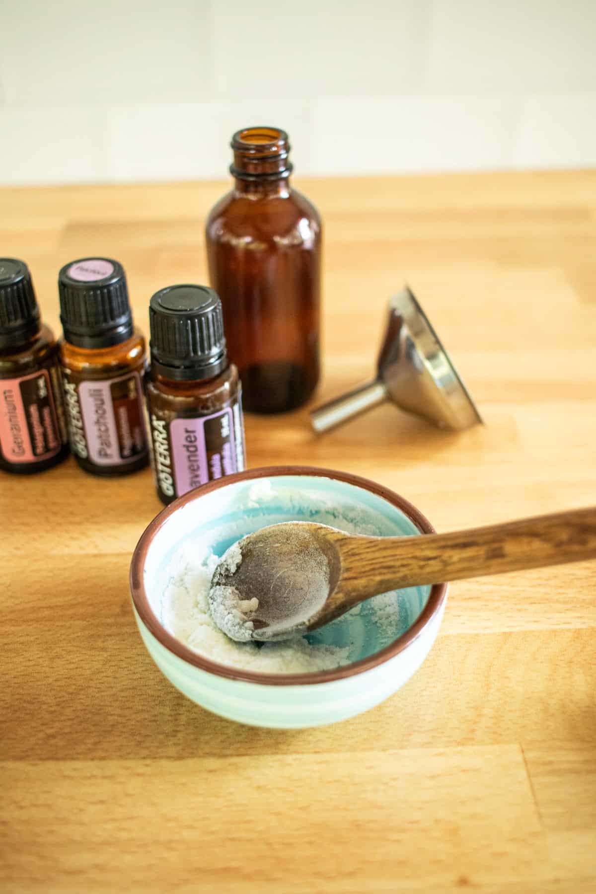 A bowl of baking soda with a spoon in it.
