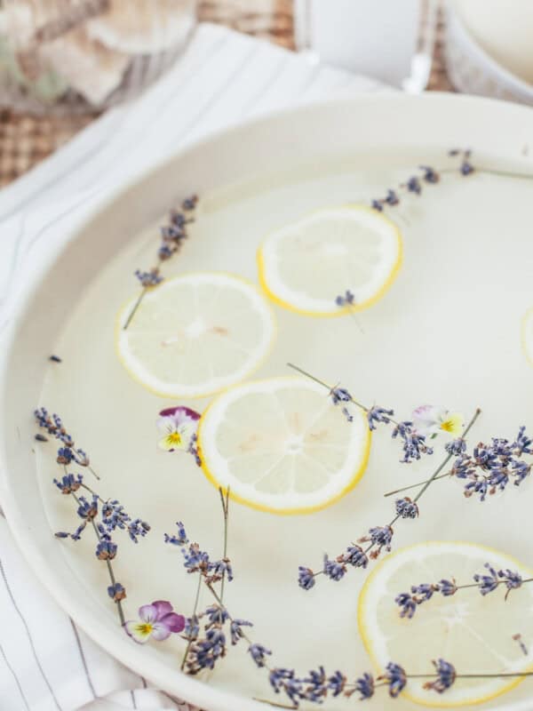 A foot soak with lemons and lavender floating in it.