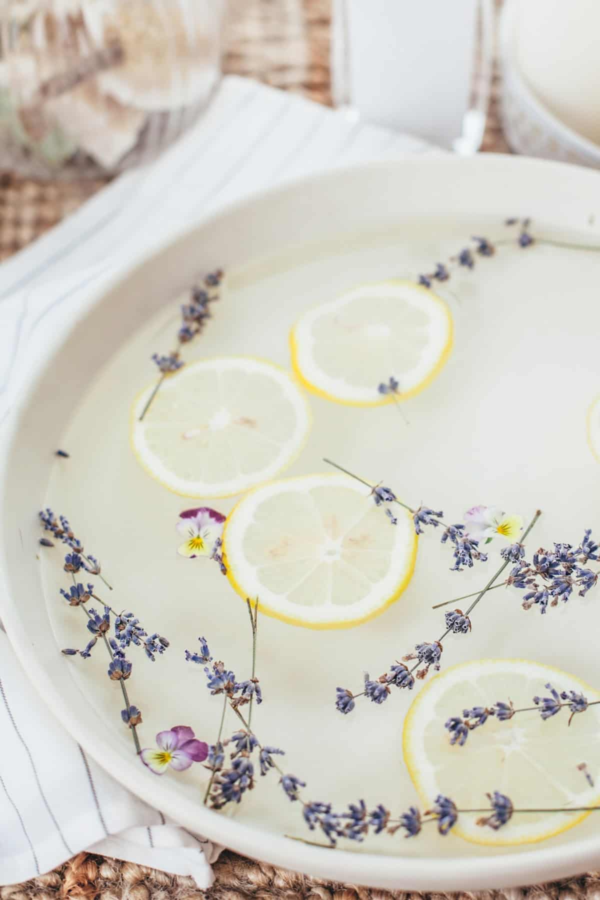 A foot soak with lemons and lavender floating in it.