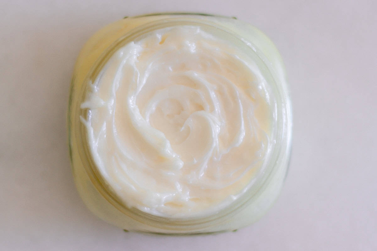 Looking down on a jar of whipped mango body butter.