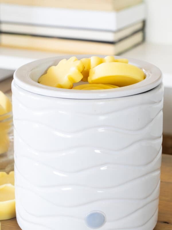 A wax warmer with homemade candle melts in the tray.