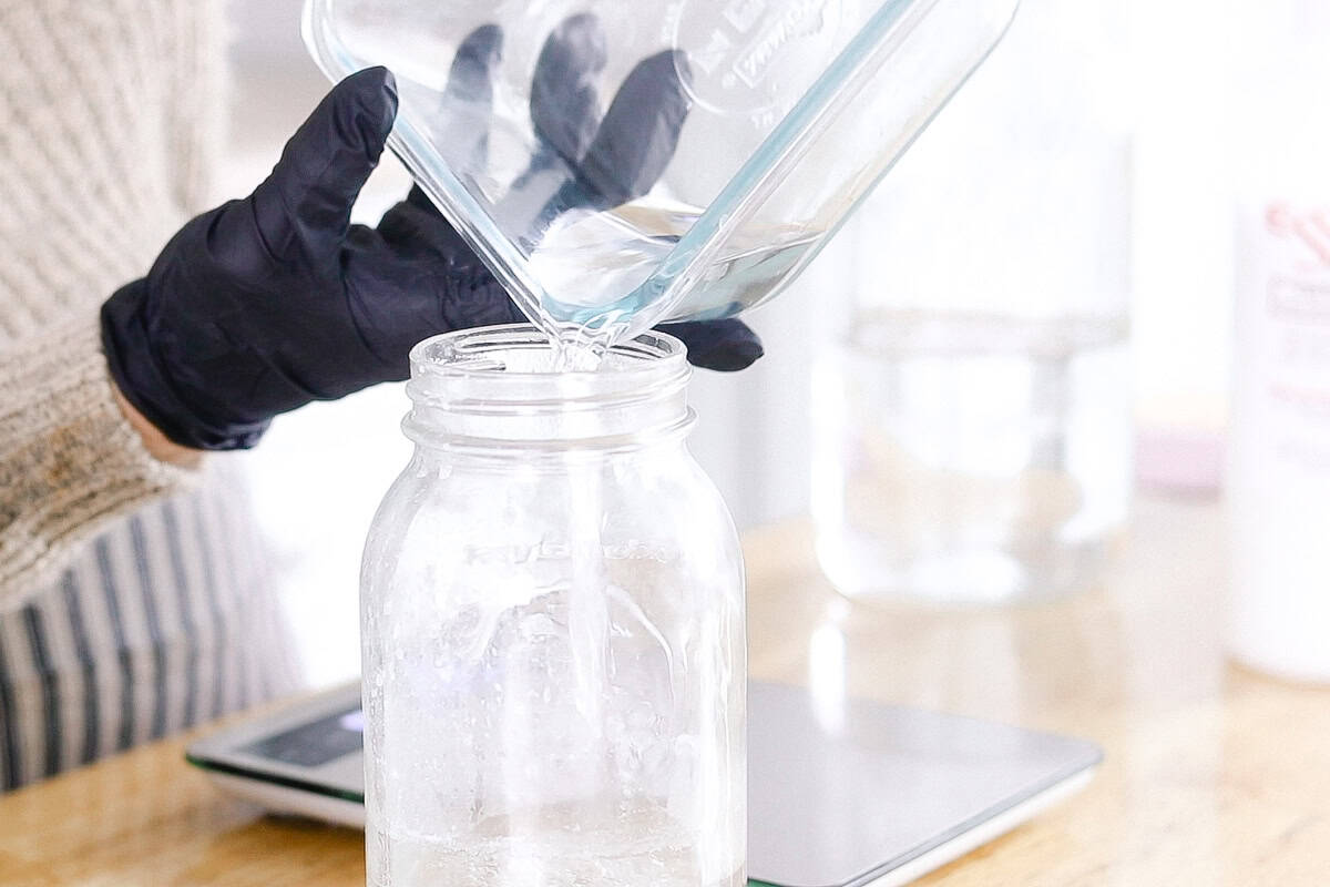 Pouring water into a jar.