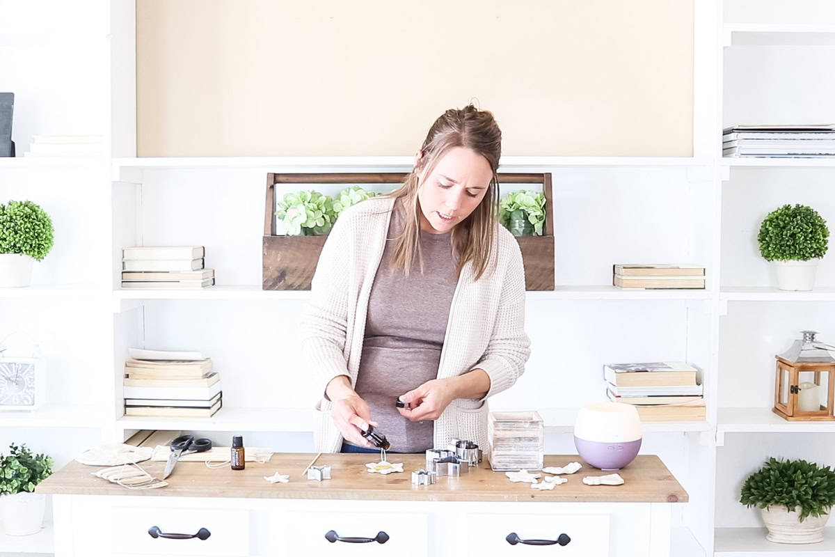 Dropping essential oils onto a clay ornament.