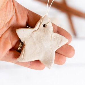 A hand holding a star-shaped diffuser ornament.