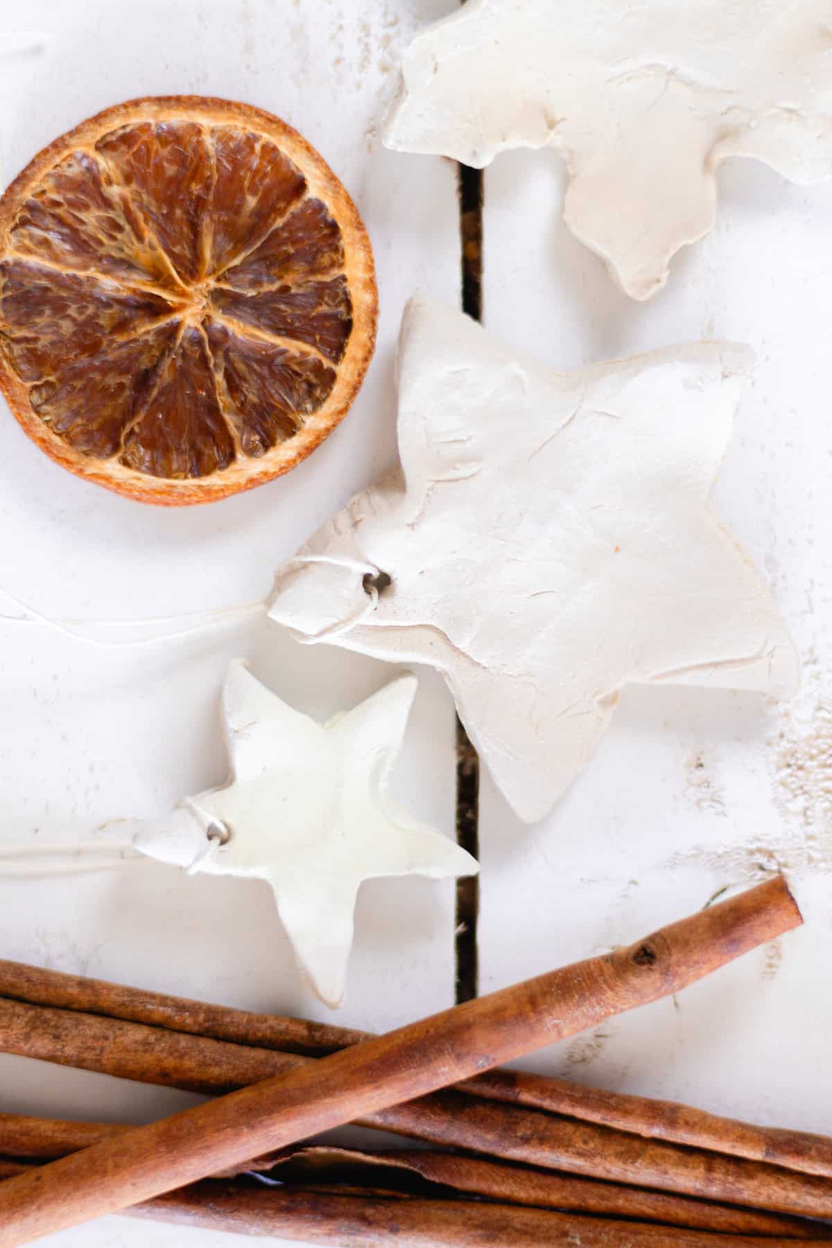 Two diffuser ornaments with a dried orange and cinnamon sticks.