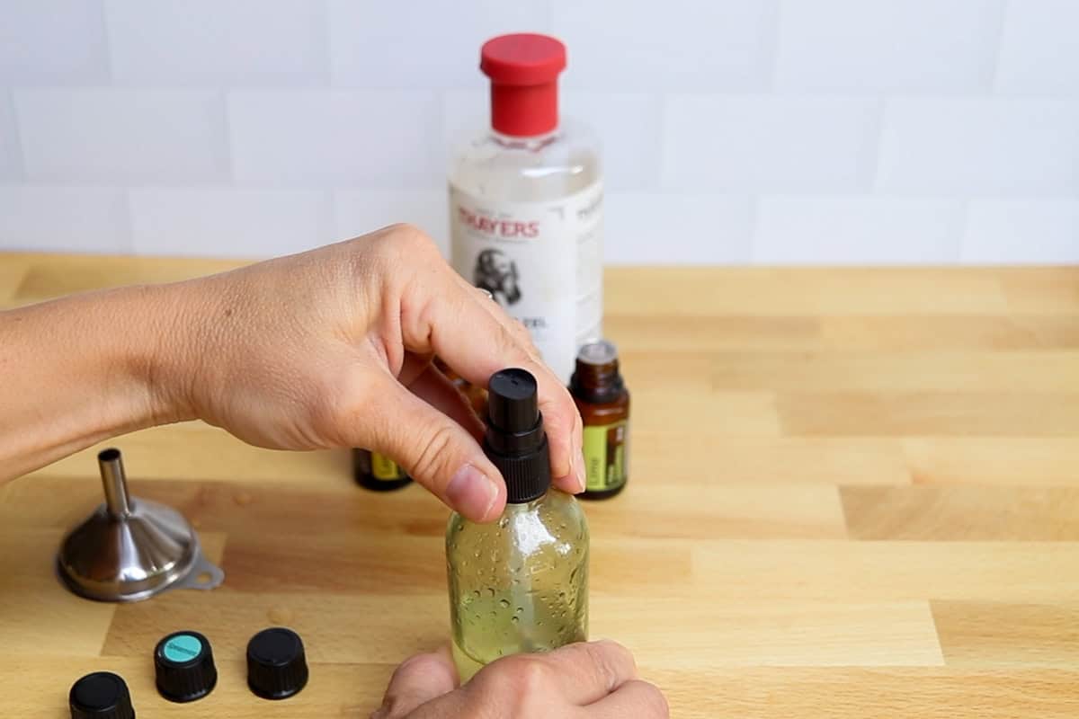 Securing the lid on the spray bottle.