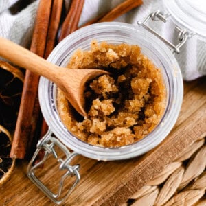 A jar of fall body scrub with a wooden spoon in it.