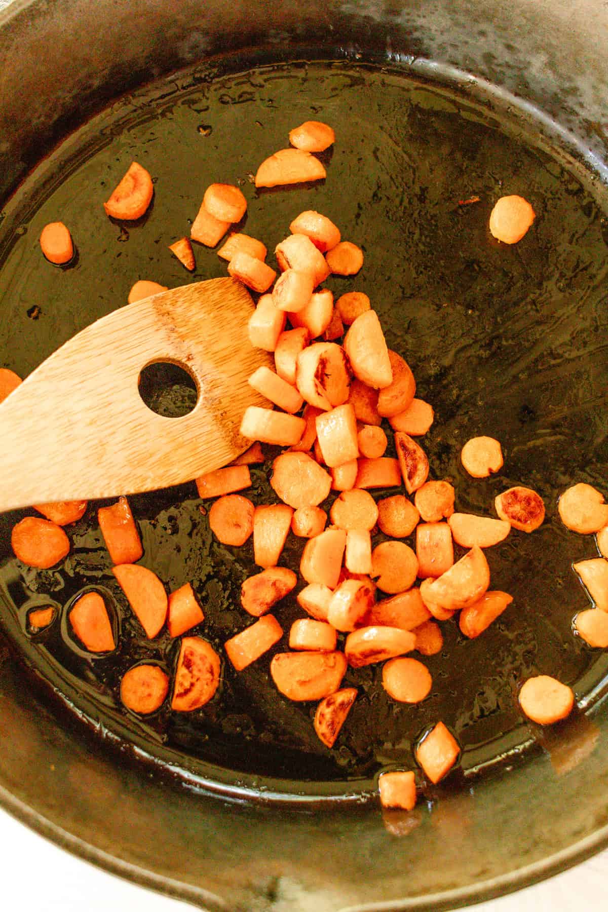 Sauteing carrots in a cast iron skillet.