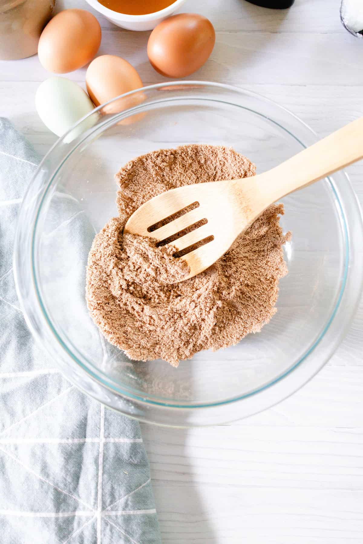 Stirring the dry ingredients together in a glass bowl.