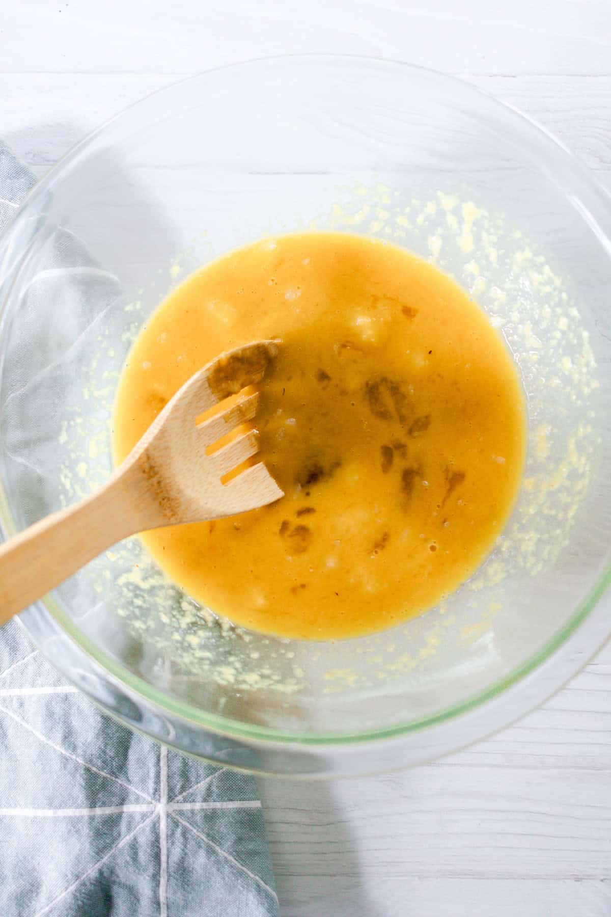 Stirring the wet ingredients together in a glass bowl.