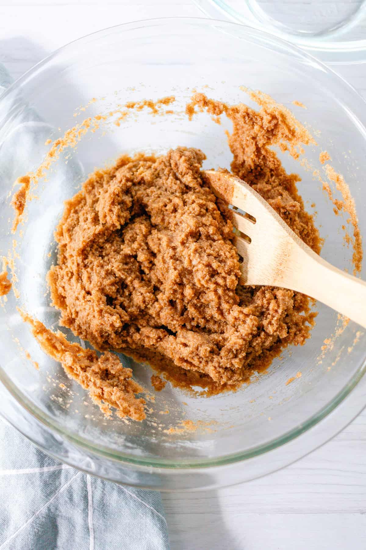 Stirring the batter together in glass bowl with a wooden spoon.