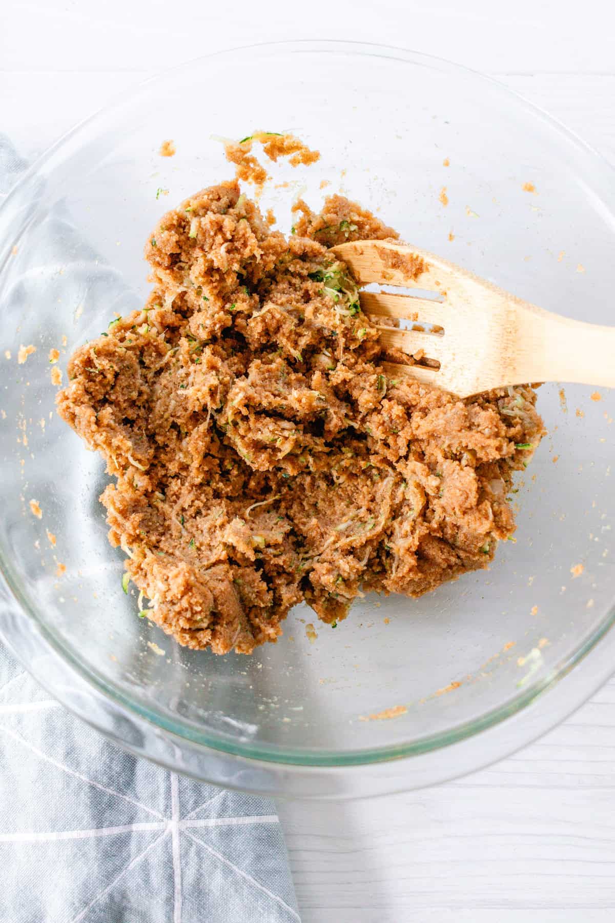 Mixing in the shredded zucchini to the bread batter.