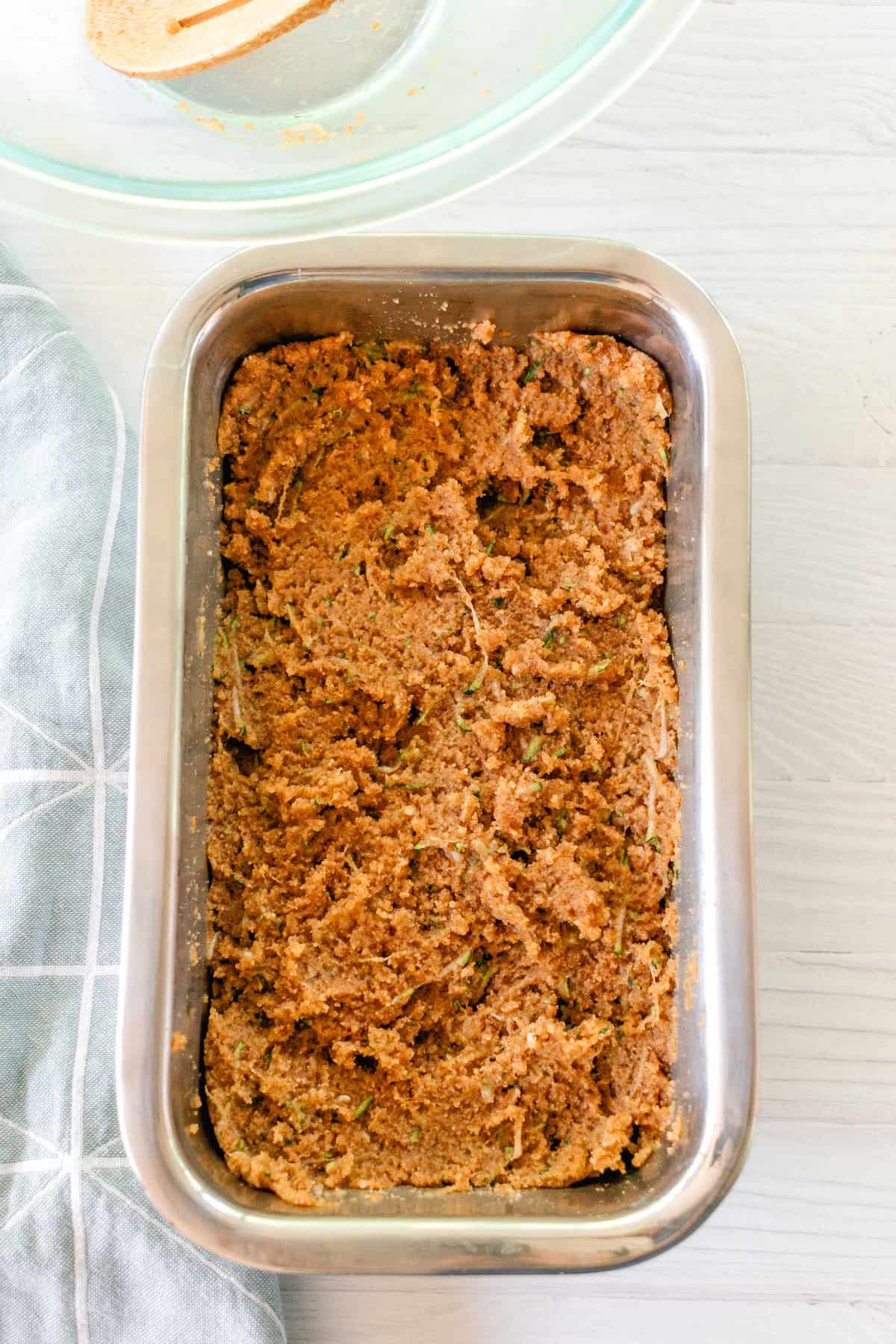Bread batter spread into a loaf pan.