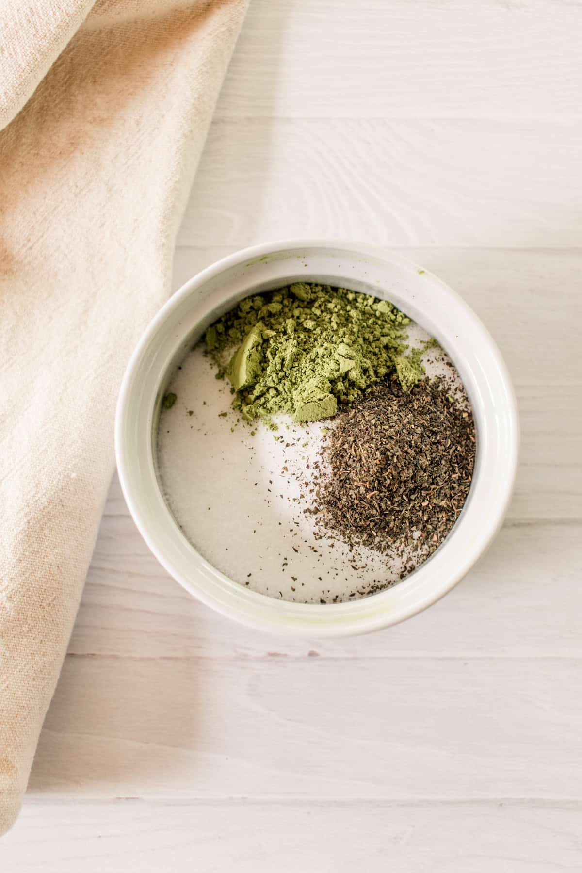 Dry ingredients for matcha scrub in a bowl.