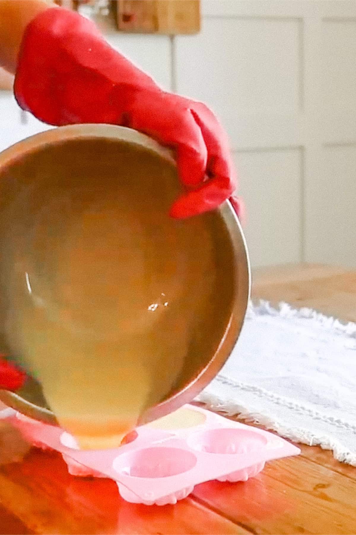Pouring the soap mixture into silicone molds.